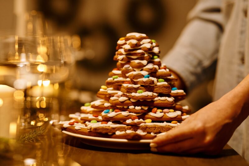 person serving a stack of biscuits on a plate